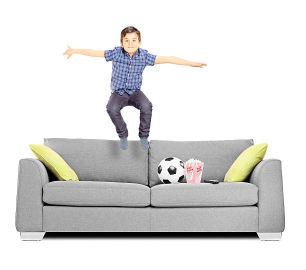 istock Happy little boy jumping on a sofa 465188013