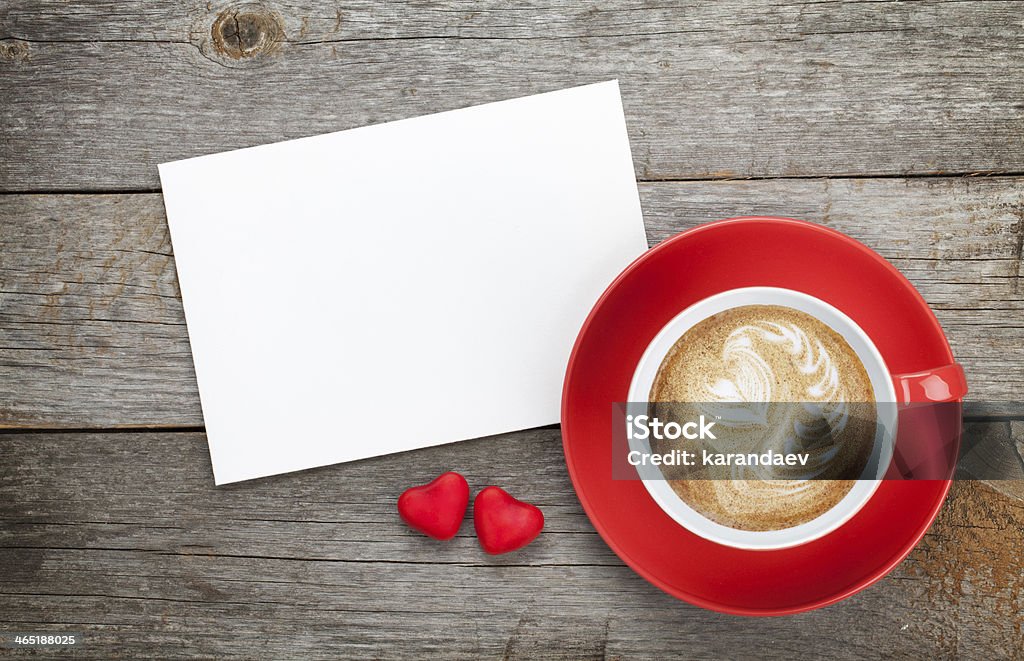 Blank valentines greeting card and red coffee cup Blank valentines greeting card and red coffee cup on wooden background Birthday Stock Photo