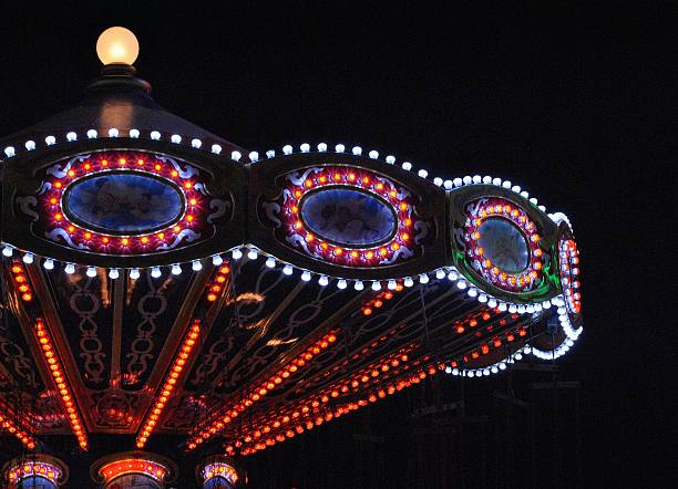 Country Fair Photographed at a country fair, an amusement park ride vividly beautiful against the night sky. midway fair stock pictures, royalty-free photos & images