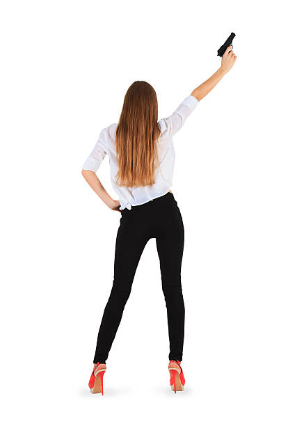 istock young woman with a pistol. Isolated on white background. 465190117