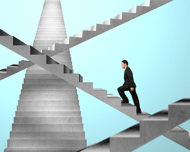 istock Businessman walking on maze stairs 465190745