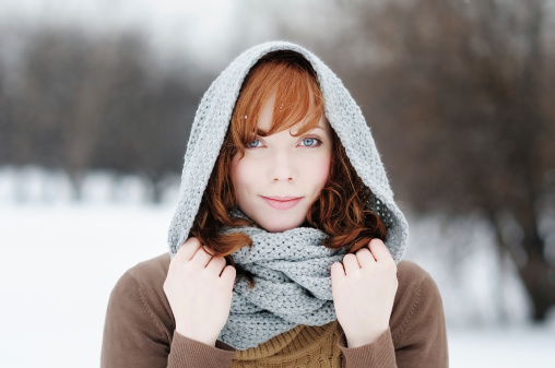 Outdoors portrait of young beautiful woman in winter
