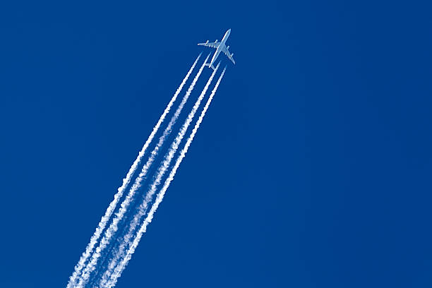 istock long trail of jet plane on blue sky 465192901