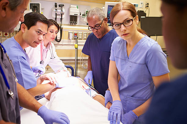 istock Medical Team Working On Patient In Emergency Room 465195233