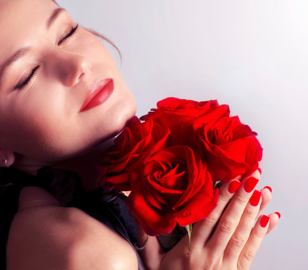 Woman, skincare glow and red rose on studio background with beauty, elegance and self love. Portrait of smile, happy and wellness model with luxury healthcare mockup, makeup cosmetics or fresh flower