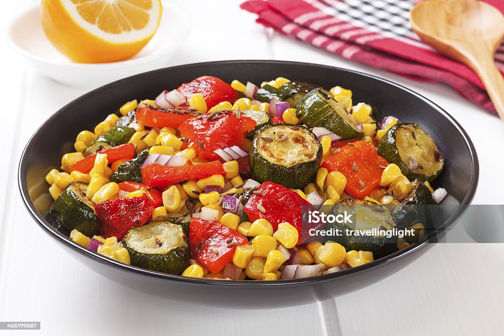 Roast Vegetable Salad Roast Vegetable Salad - vegetable salad of roast courgette or zucchini, roasted red capsicum or pepper, sweetcorn and red onion with toasted cumin seeds. Bell Pepper Stock Photo