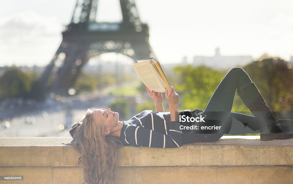 Girl reading book in Paris on a sunny day Girl reading a book in Paris on a sunny day Reading Stock Photo