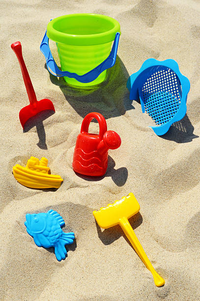 istock Plastic children toys on the sand beach 465203143