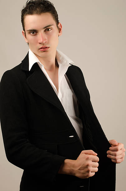 istock Young businessman in long coat 465205287