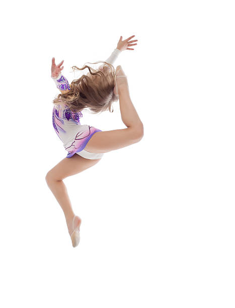 istock Graceful little artistic gymnast posing in jump 465211139