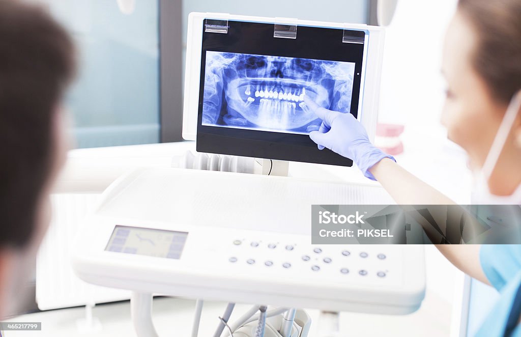 Dentist explaining x ray picture to patient Dental Equipment Stock Photo