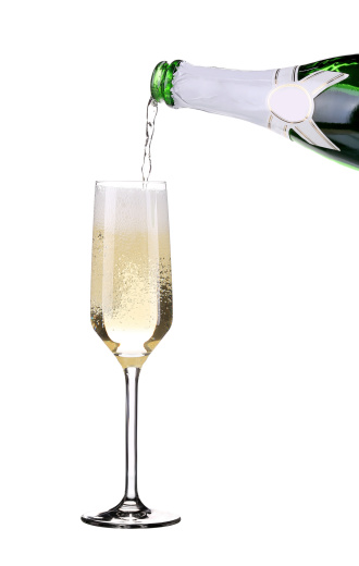 Champagne pouring in a glass. Isolated on a white background.