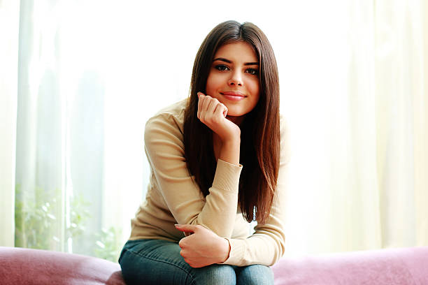 istock Young beautiful happy woman sitting on the sofa 465227779