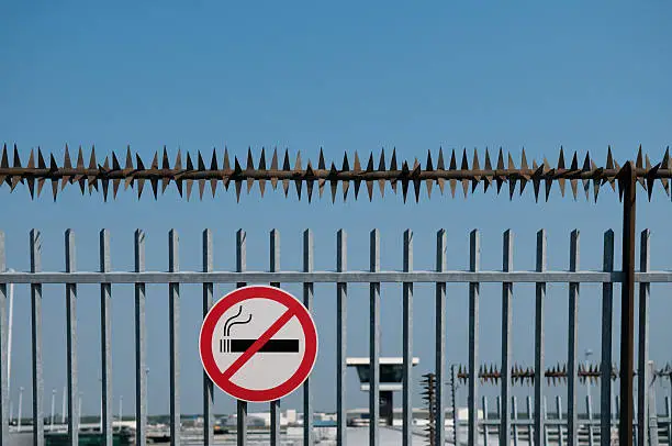 Airport security fence on sunny summer day.