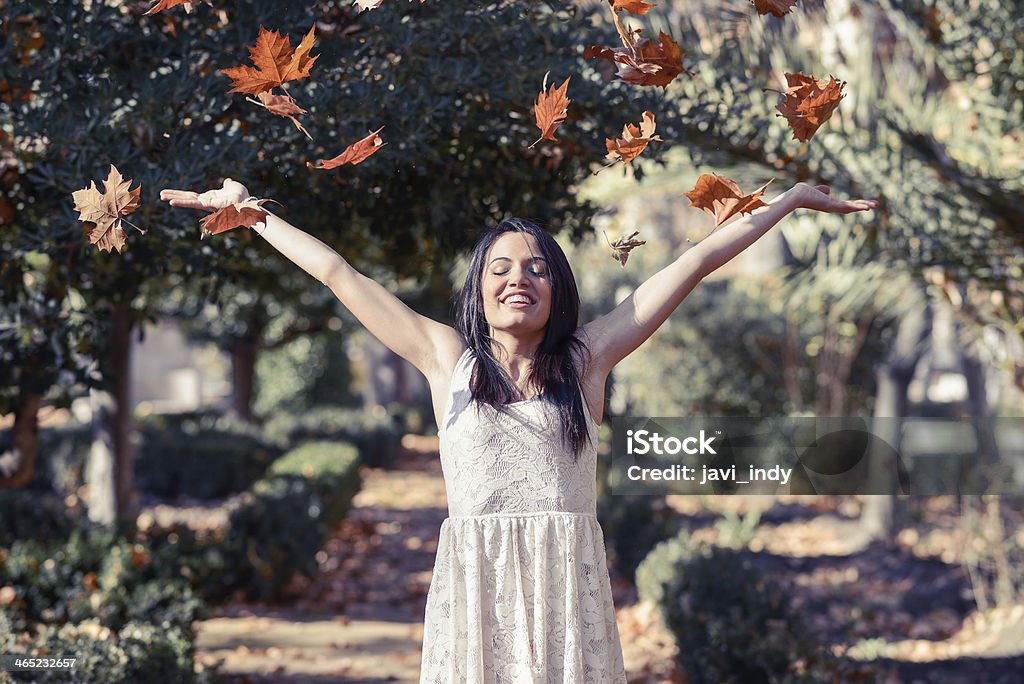 Beautiful brunette girl with falling leaves in the autumn Portrait of beautiful brunette girl with falling leaves in the autumn 16-17 Years Stock Photo