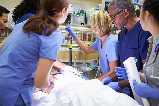 istock Medical Team Working On Patient In Emergency Room 465233385