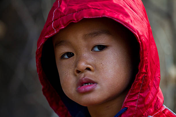 istock asian boy on cold winter day 465236325