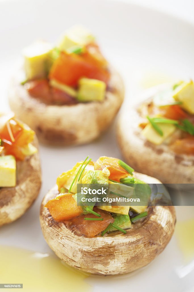 baked stuffed champignons with vegetables Avocado Stock Photo