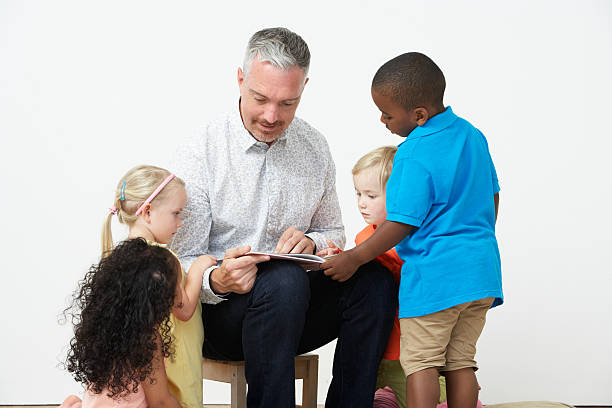 istock Pre School Teacher Reading Story To Children 465245355