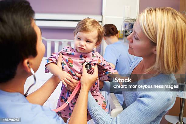 Mother Holding Her Daughter During A Medical Examination Stock Photo - Download Image Now