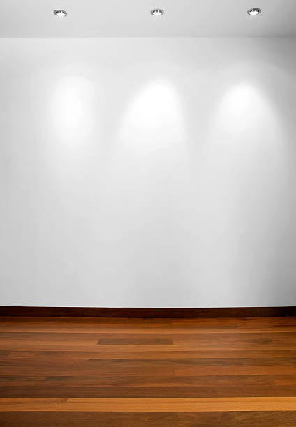 istock Empty white wall with 3 spot lights and wooden floor 465247633