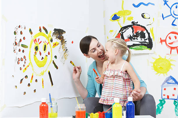 istock Teacher And Pupil In Pre School Art Class 465247863