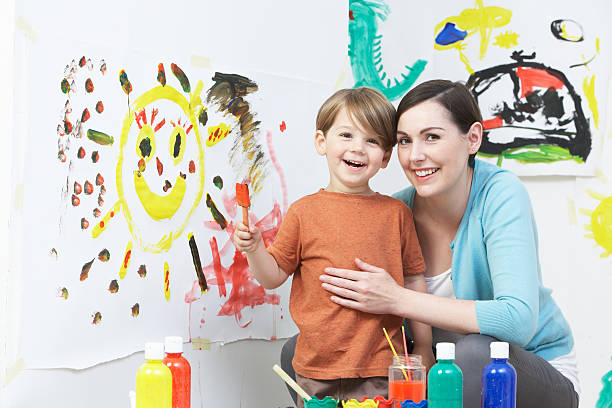istock Teacher And Pupil In Pre School Art Class 465247969