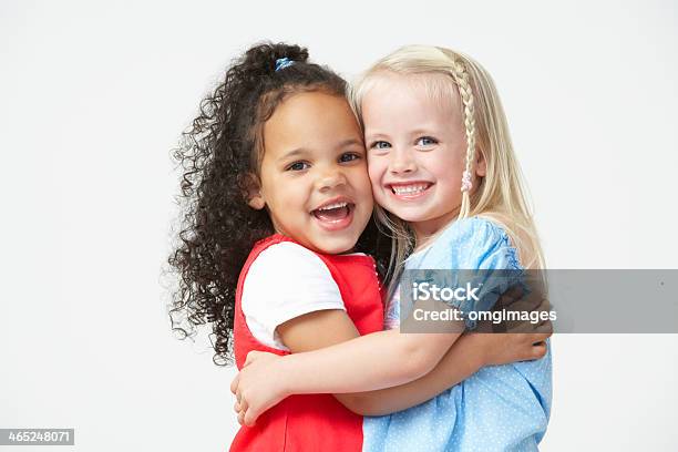 Two Pre School Girls Hugging One Another Stock Photo - Download Image Now - Child, Embracing, White Background