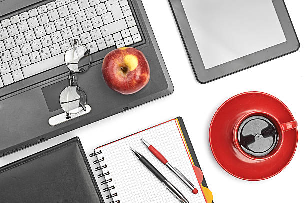 istock Laptop and office supplies on white 465249045