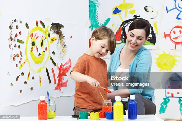 Young Female Teacher And Pupil In Preschool Art Class Stock Photo - Download Image Now