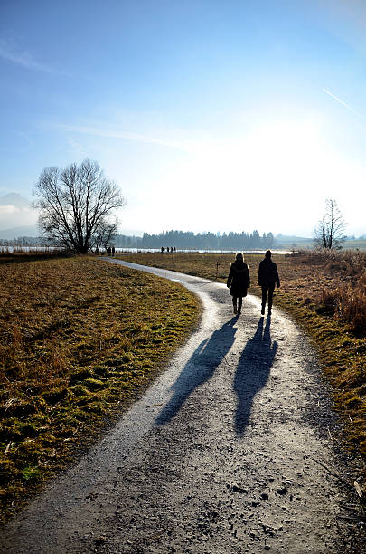 istock Two people walking on a dirt road 465250103