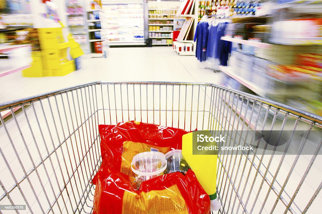 Shopping - In The Supermarket shopping cart standing between shelves in the supermarket Stock Market and Exchange Stock Photo