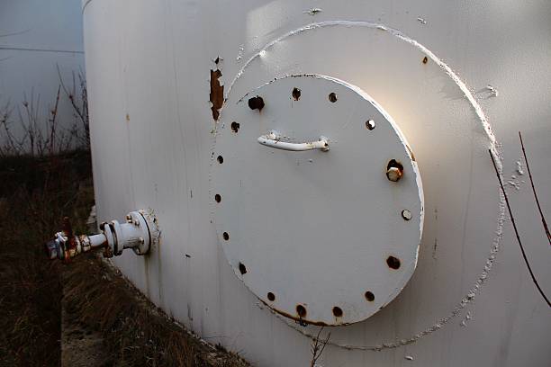 istock Old hatch on the white storage tank 465250349