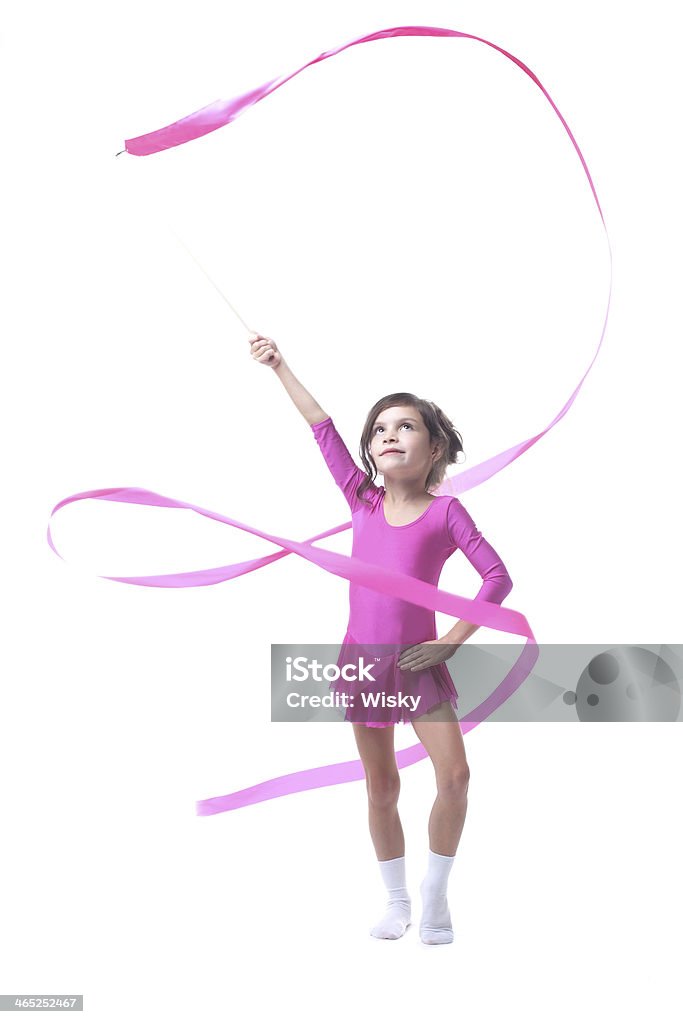 Adorable little gymnast dancing with ribbon Adorable little gymnast dancing with ribbon, isolated on white Award Ribbon Stock Photo