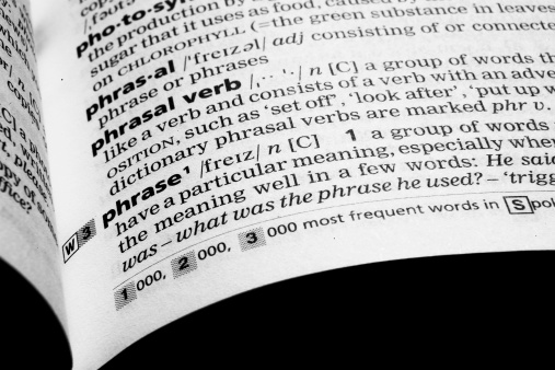 Closeup shot of the word PHRASE in a dictionary. Flush of the dictionary can be seen at page opening. Focus is on the word phrase.