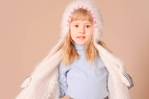 istock Smiling girl wearing winter clothes in studio 465257849
