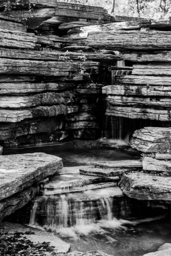 A black and white Image of a rock waterfall