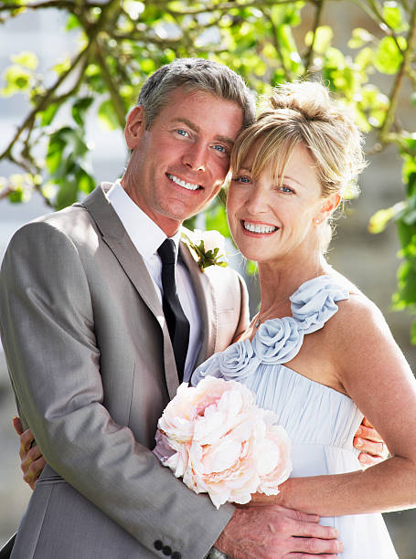 istock Romantic Bride And Groom Embracing Outdoors 465258265