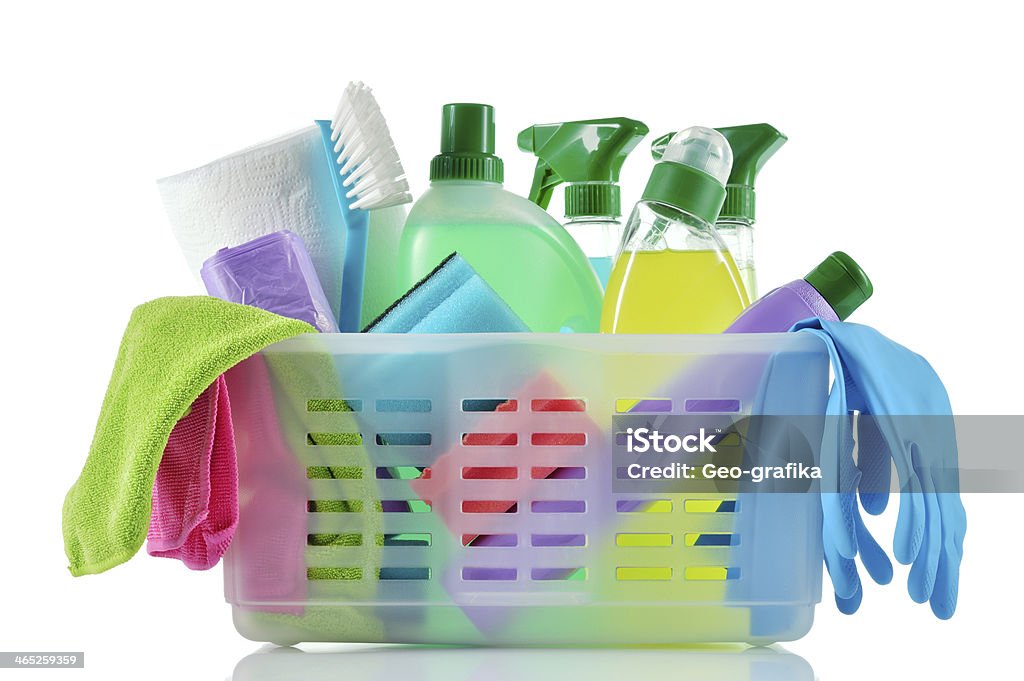 A basket full of cleaning supplies and cloths Cleaning products and supplies in a basket. Cleaners, microfiber cloths, gloves  in a basket isolated on white background. Cleaning kit. Cleaning Stock Photo