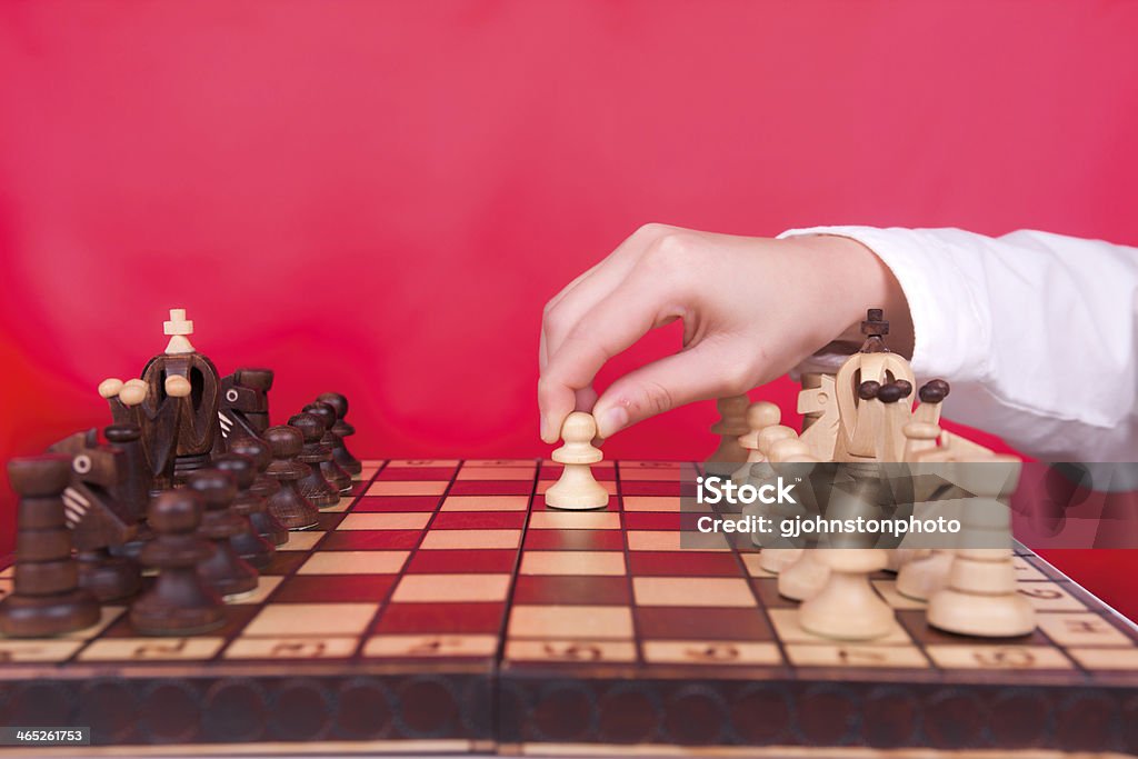 Playing the pawn first. A player makes the first move by moving out the pawn. Challenge Stock Photo