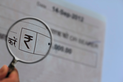 Magnifying Glass Bank Cheque Concept