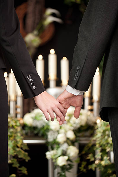 istock People at funeral consoling each other 465274699