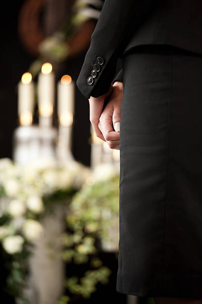 istock woman at funeral mourning 465274729