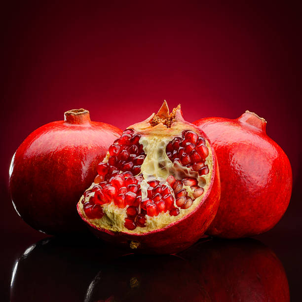 istock pomegranate fruits on a dark background 465279635