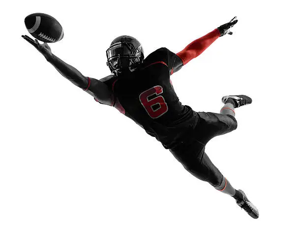 Photo of american football player catching ball silhouette