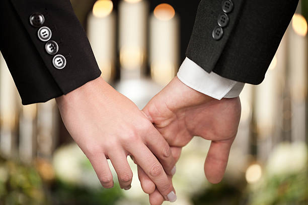 istock People at funeral consoling each other 465281847