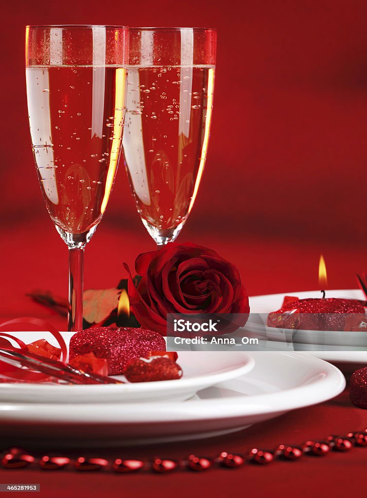 Romantic table setting Photo of beautiful red romantic table setting, white festive utensil with romantic decorations, two glass of wine, alcohol beverage, rose flower, Valentine day, romance and love concept Alcohol - Drink Stock Photo