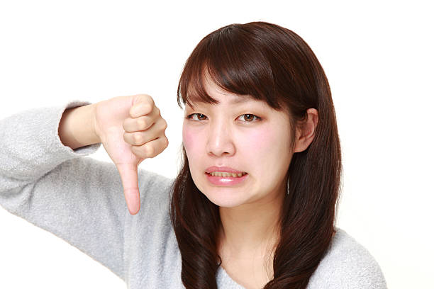 istock woman with thumbs down gesture 465282216