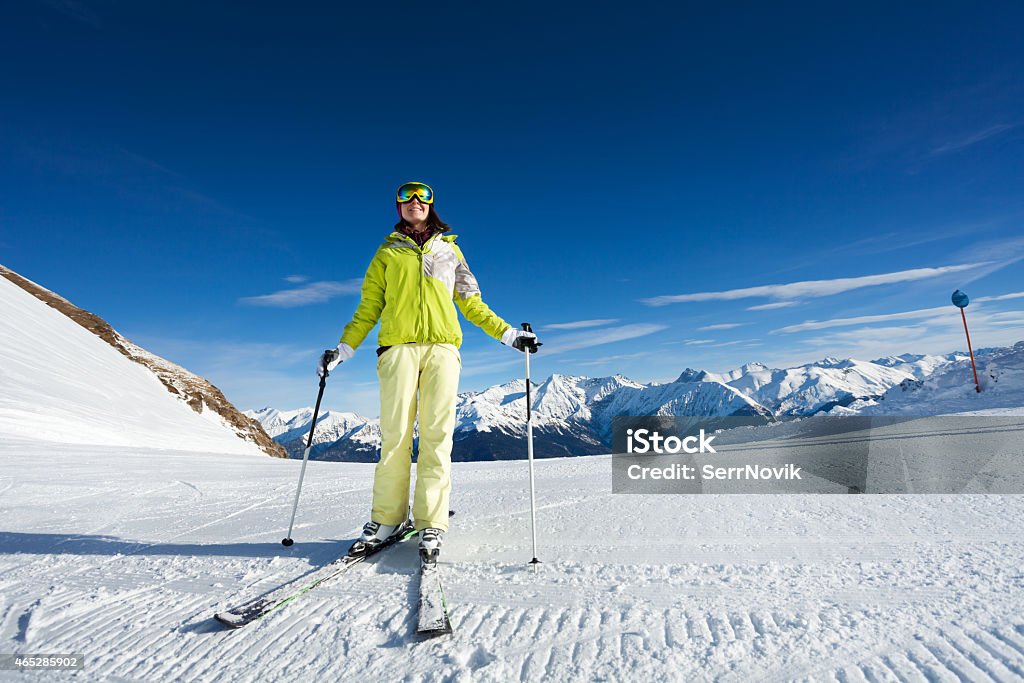 Happy woman in mask skiing on ski-track slone Happy woman in mask skiing on ski-track at Krasnaya polyana ski resort and Caucasus mountains in Sochi, Russia 2015 Stock Photo