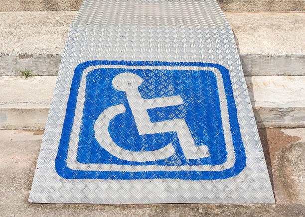 The blue sign indicating on wheelchair usage on steel ramp for disabled people.